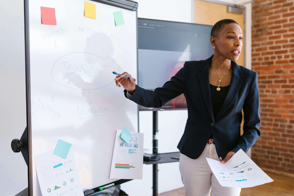 trainer leading a session with white board and sticky notes