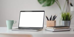 blank laptop screen on home office desk